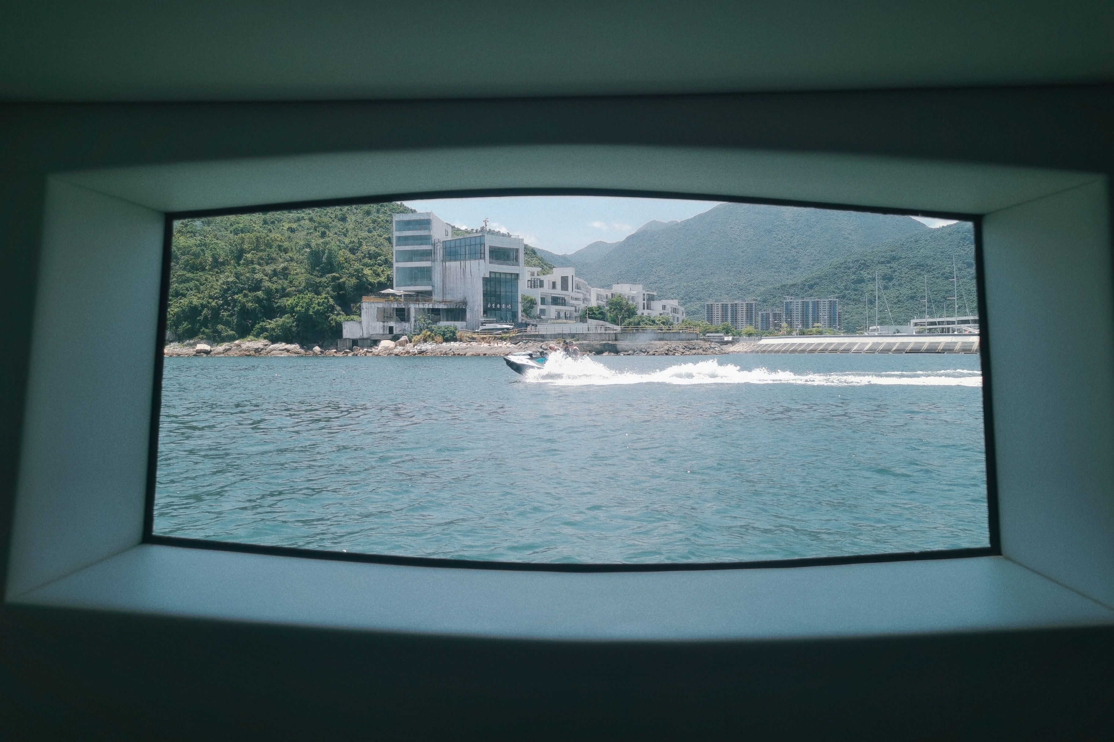 Scenic Coastal View Through Ship Window · Free Stock Photo