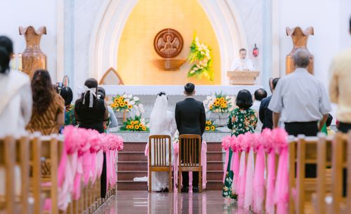 Free Bride and groom at altar during a church wedding with guests in attendance. Stock Photo