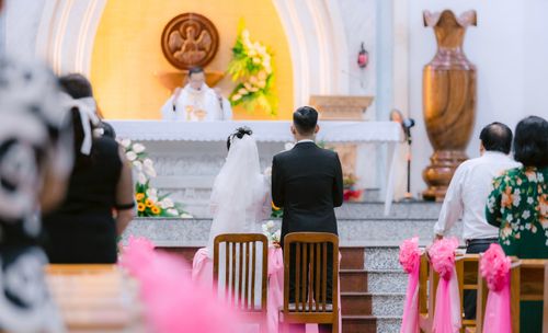 Free Bride and groom kneeling during a church wedding ceremony. Stock Photo