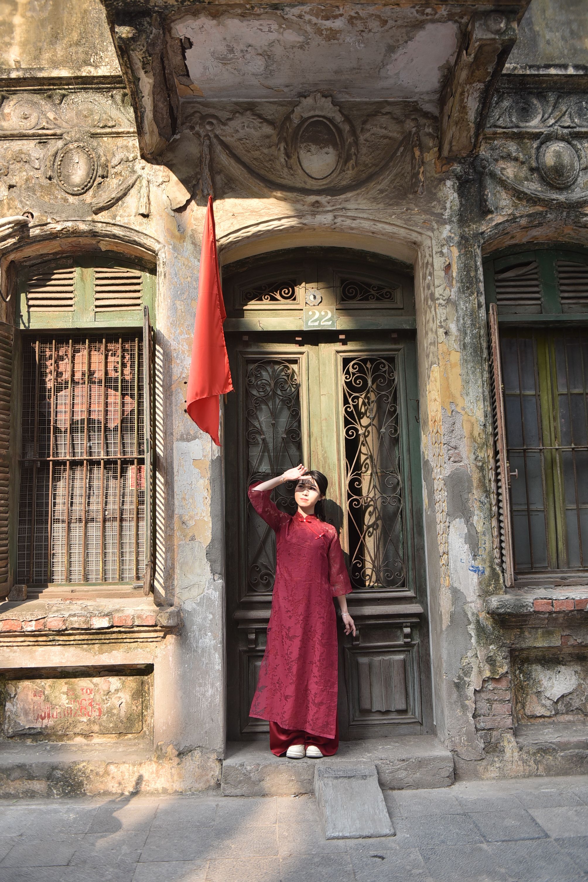 Woman in Red Dress Posing by Historical Doorway · Free Stock Photo