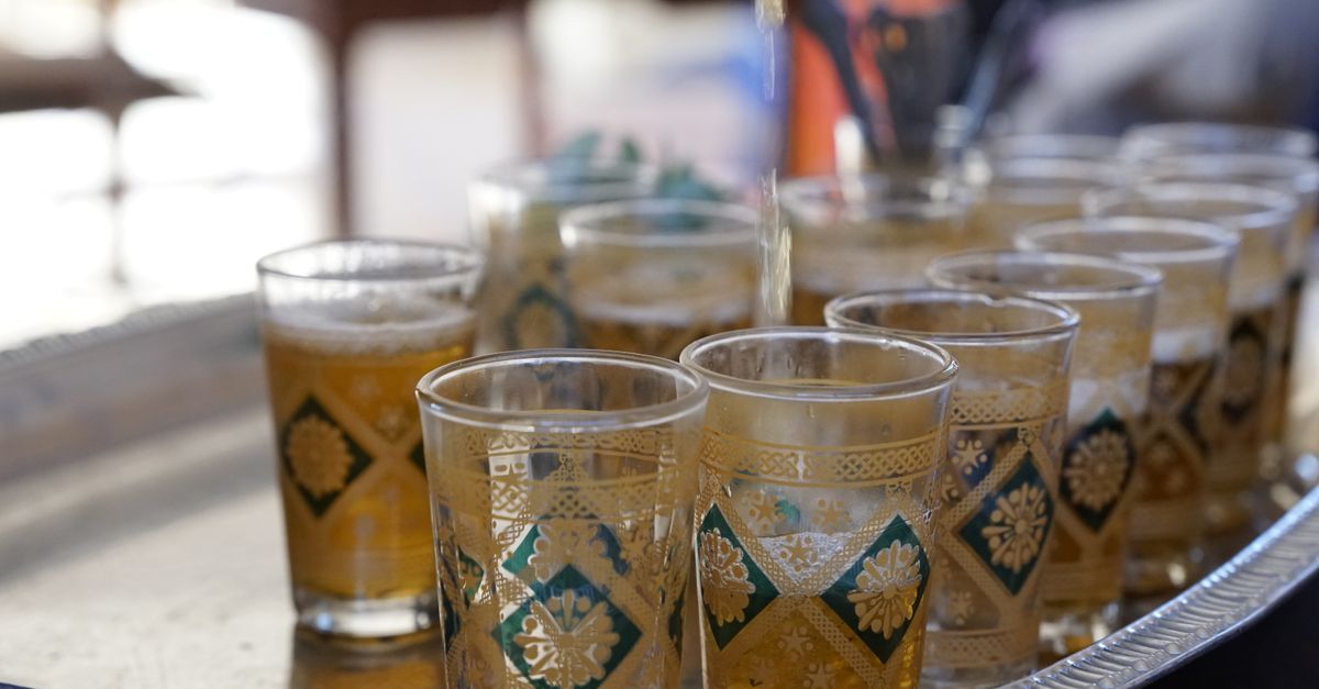 A vibrant Moroccan tea ceremony with ornate glasses in Drâa-Tafilalet.