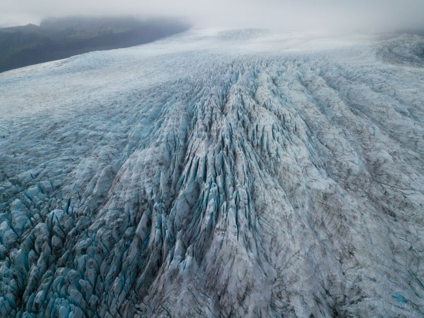 Breathtaking aerial shot of an expansive glacier in Þingeyjarsveit, Iceland, showcasing natural ice formations.