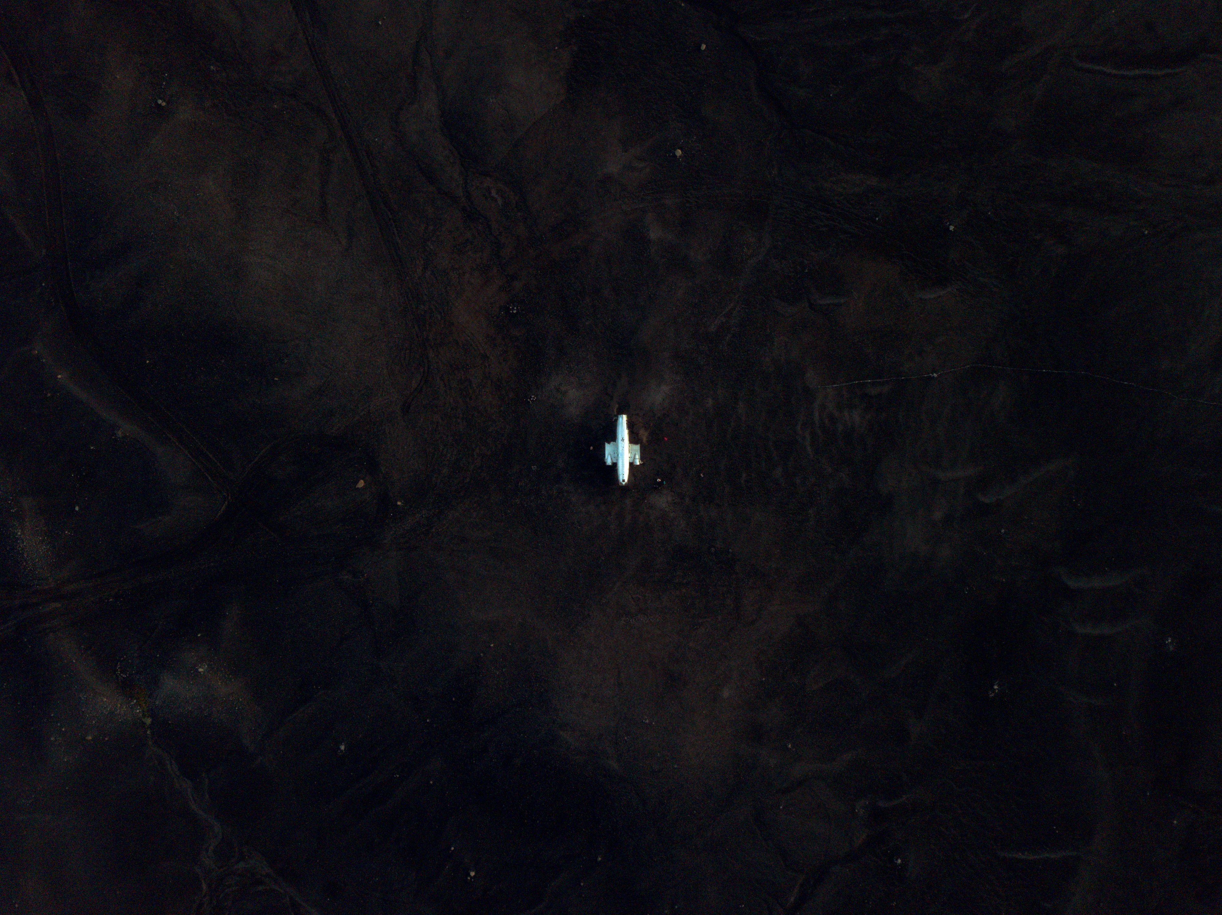 Amazing Iceland Volcanic Eruption Area Helicopter Tour from Reykjavík Review Review 2026 - Aerial perspective of a solitary vehicle on dark, vast Icelandic landscape.