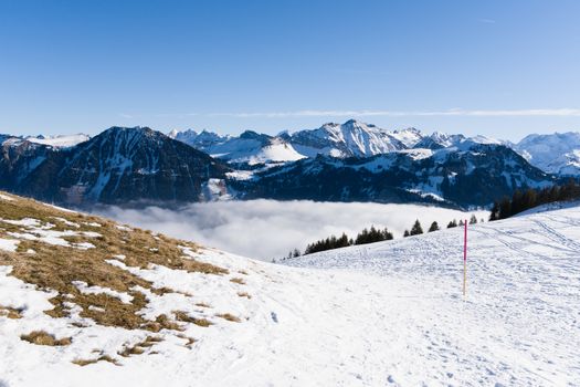 Stunning view of snowy Swiss Alps under a clear blue sky, ideal for nature enthusiasts.