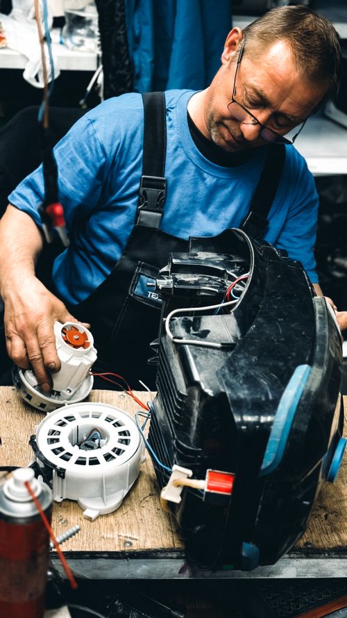 Technician inspecting a washing machine for a leak guide