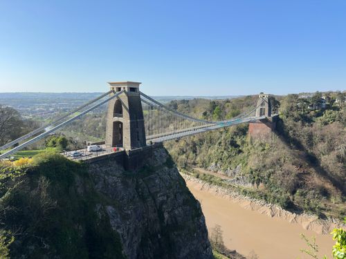 Free Scenic view of Clifton Suspension Bridge spanning the Avon Gorge under clear blue skies in Bristol. Stock Photo