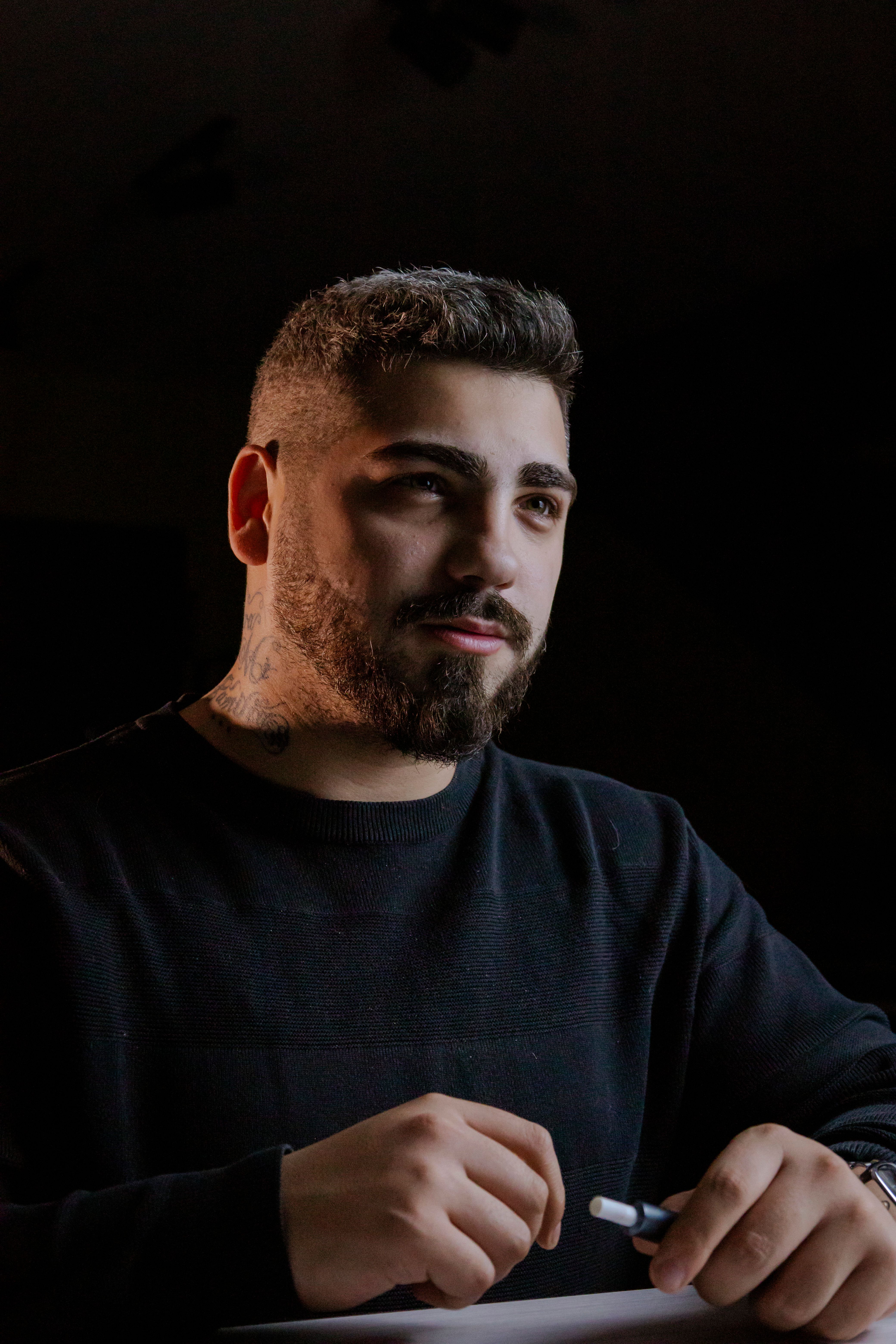Portrait of a Pensive Young Man in Dark Lighting