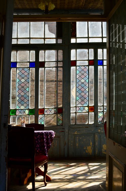 Free Sunlight streaming through a stained glass window in a quaint Tbilisi cafe. Stock Photo