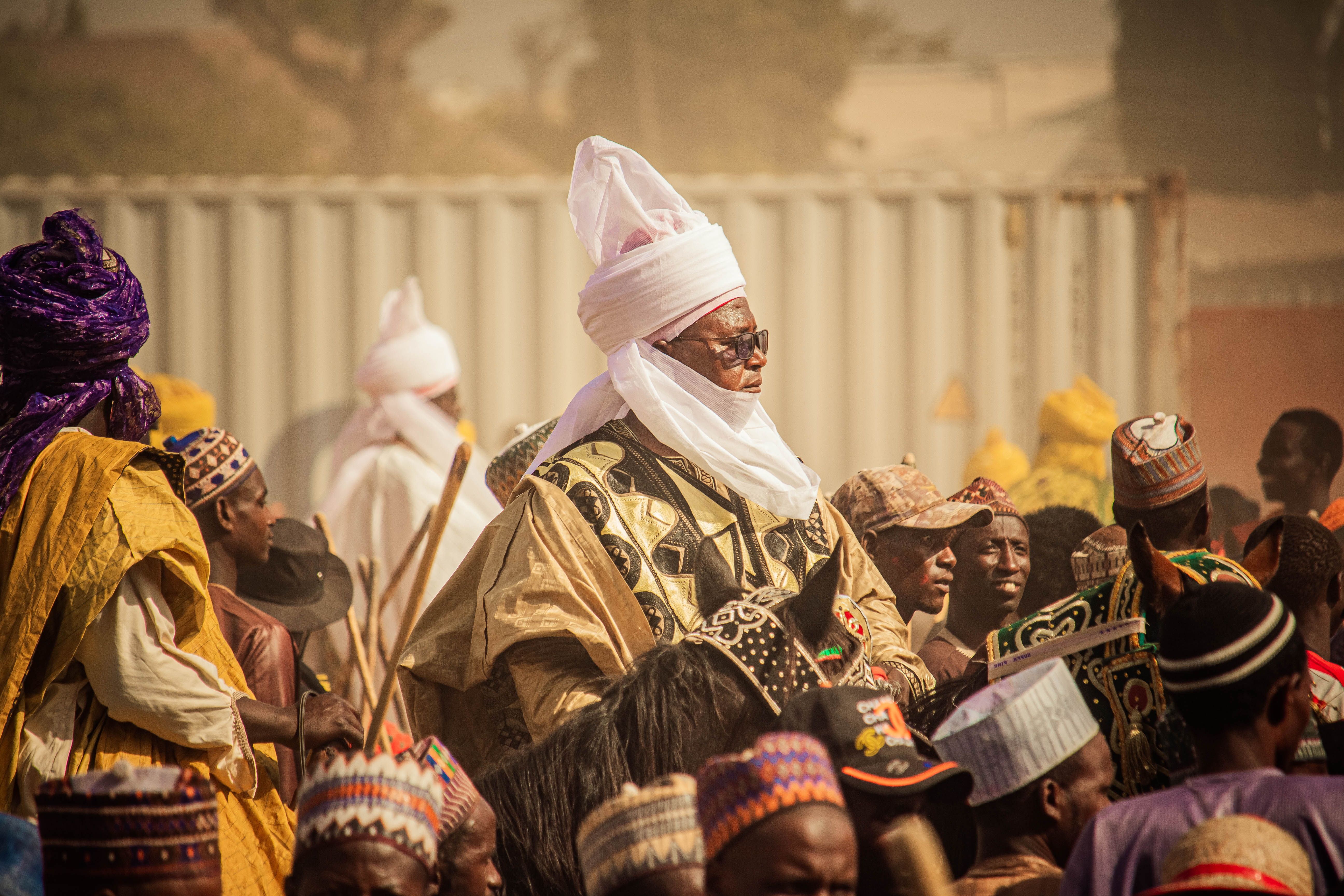 Vibrant celebration featuring traditional African attire amidst a lively crowd.