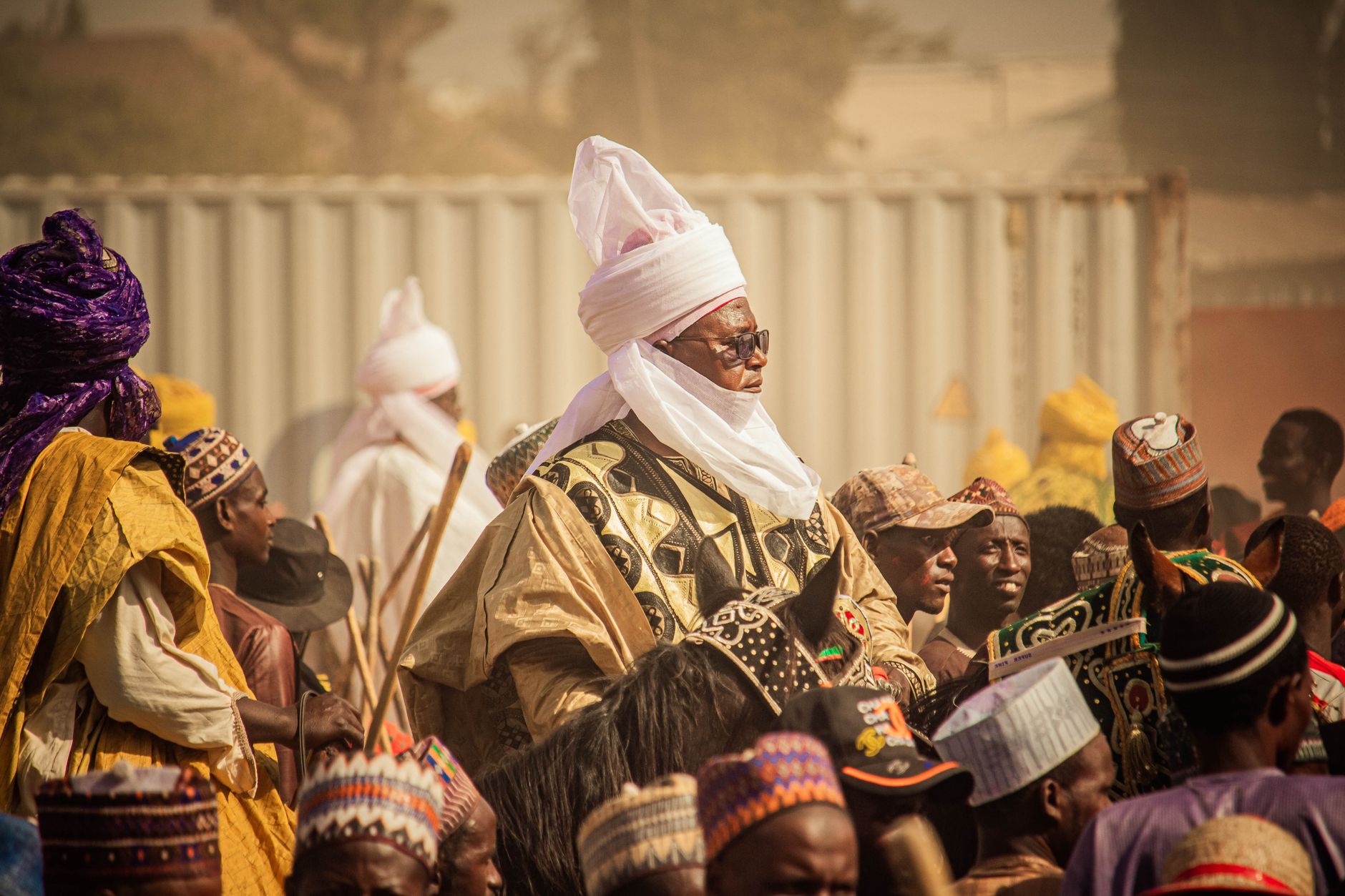 Vibrant celebration featuring traditional African attire amidst a lively crowd.