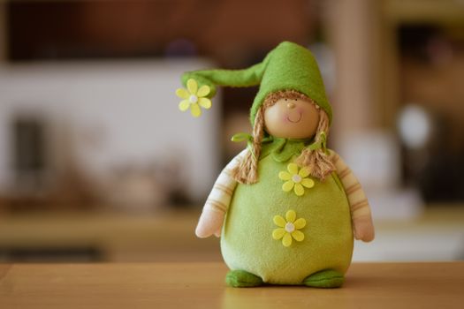 Adorable green plush toy with a flower accent, perfect for decoration or gifts.