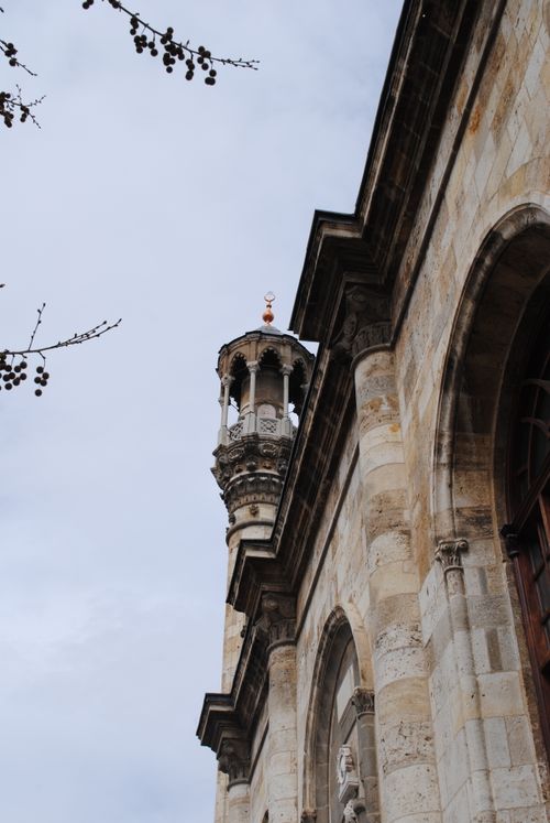 Free View of a historical minaret in Konya, Türkiye, showcasing intricate architectural details against cloudy skies. Stock Photo