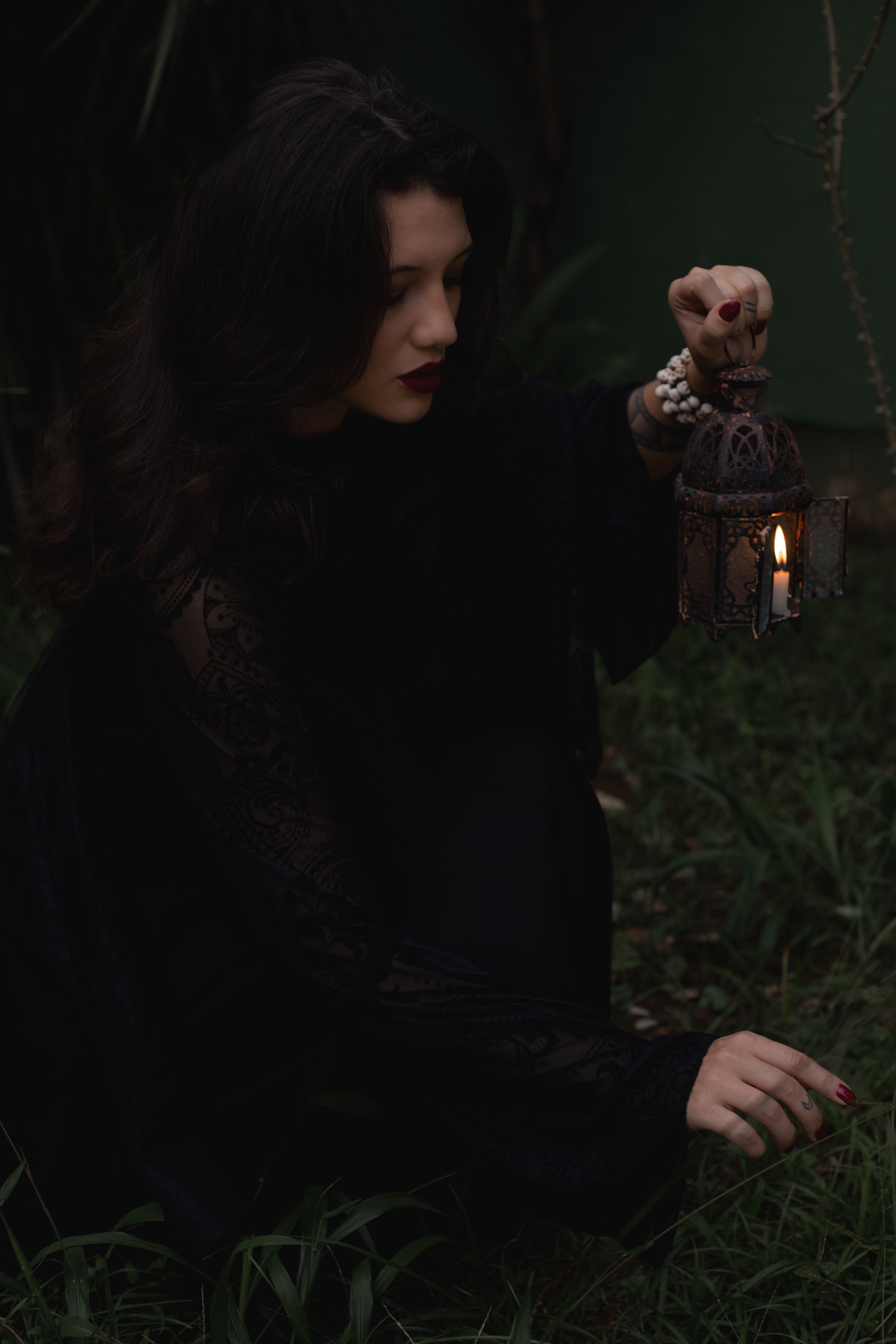 Mysterious Woman Holding Lantern in Dark Garden · Free Stock Photo