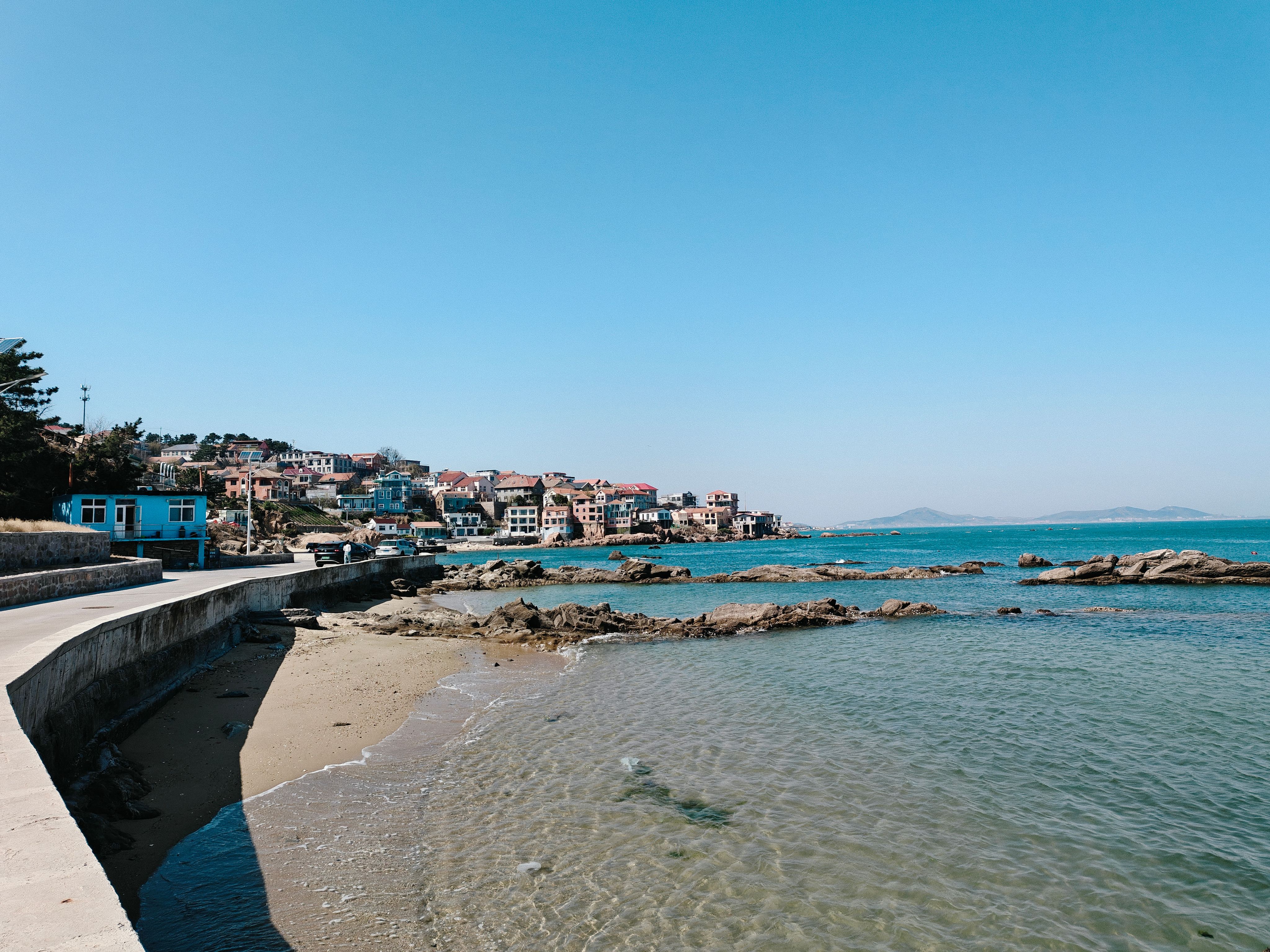 Scenic Coastal Town with Rocky Shoreline · Free Stock Photo