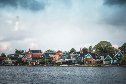 Free Idyllic wooden houses along the river in Zaanse Schans, Zaandam, showcasing traditional Dutch architecture. Stock Photo