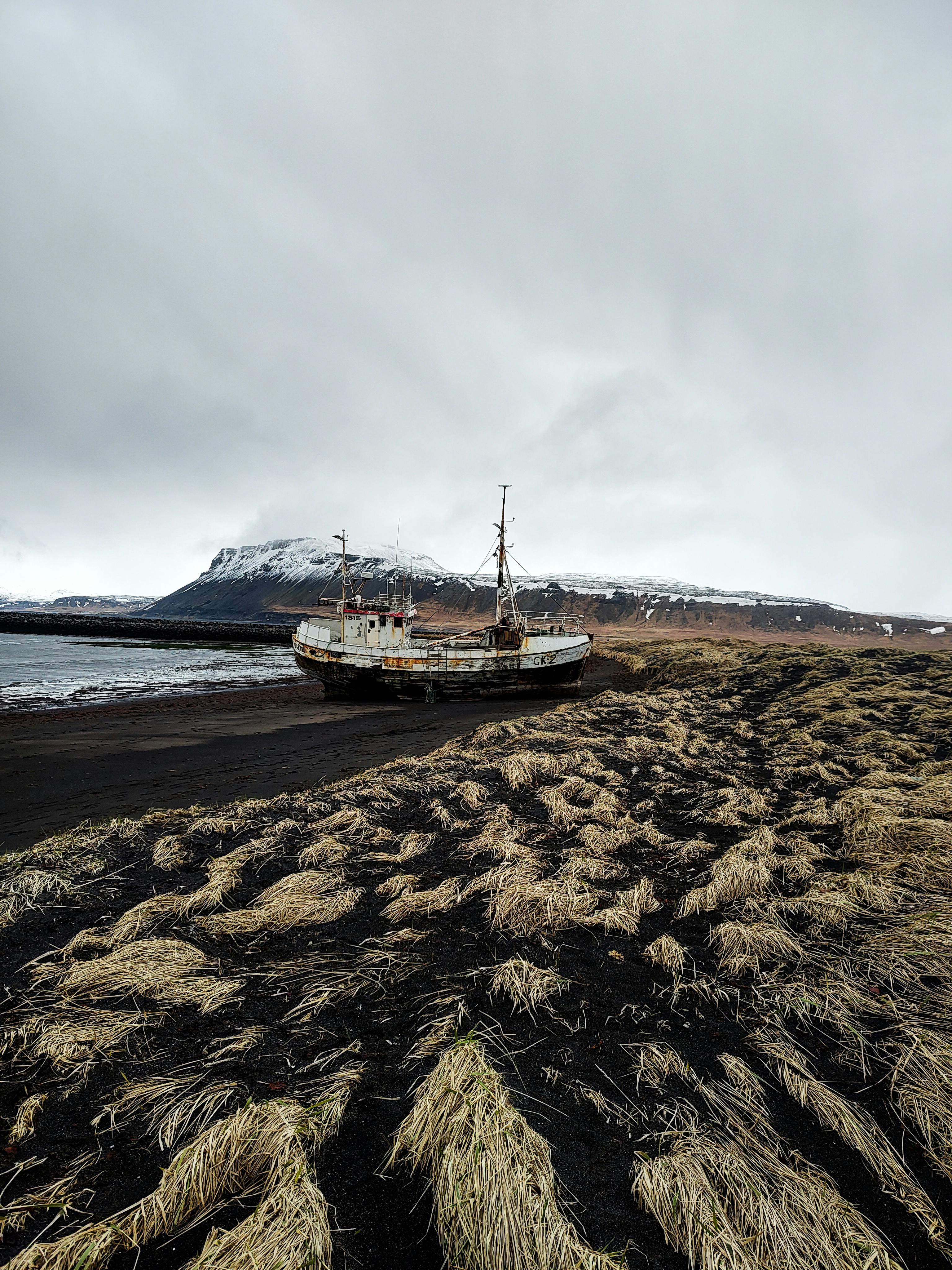 abandoned ship on icelandic black sand beach
