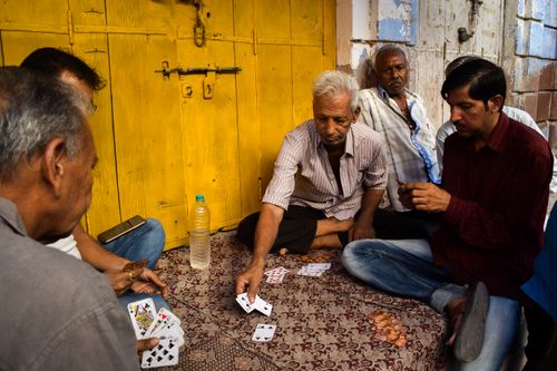 Free A group of men enjoying a card game on a street in Jodhpur, India, showcasing local culture. Stock Photo