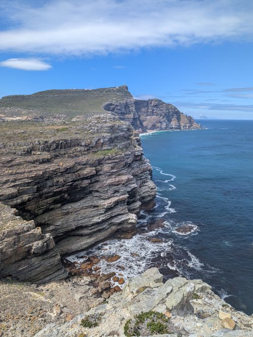 Free Stunning view of Cape Point's dramatic cliffs and coastline under a clear blue sky. Stock Photo