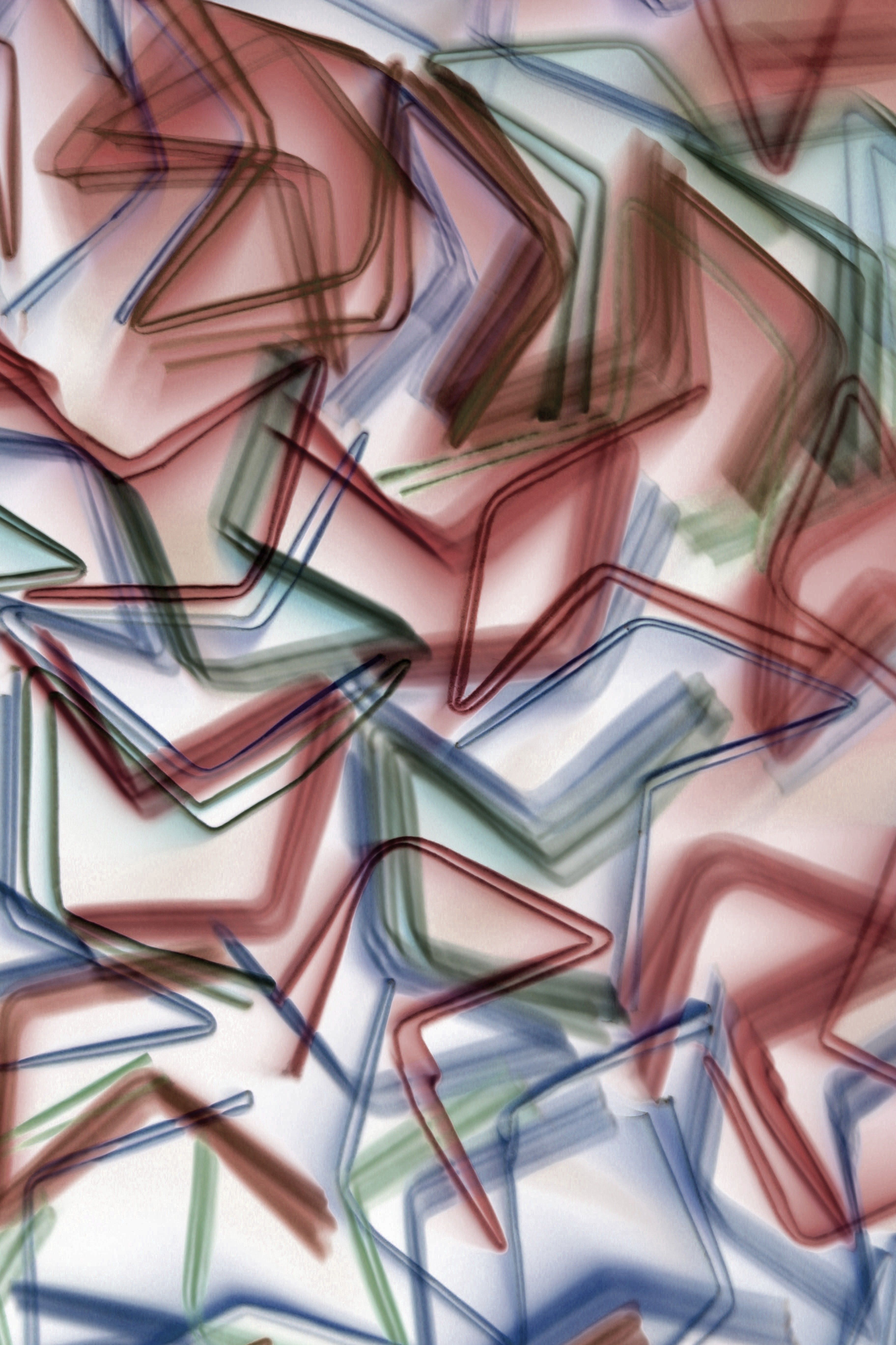 Abstract background featuring overlapping geometric shapes in various colors, creating a dynamic visual effect.