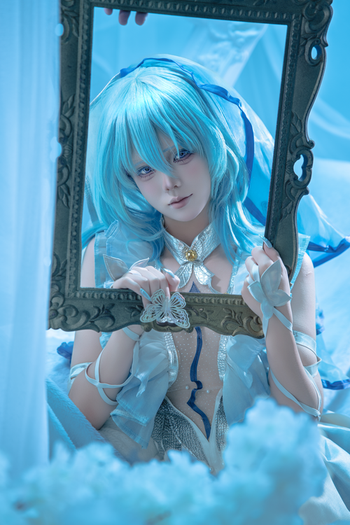 Free A person in blue anime cosplay posing with a decorative frame and butterfly motif. Stock Photo