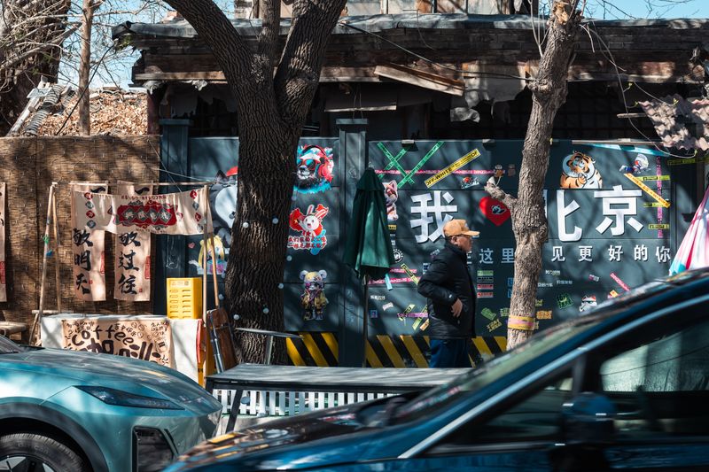 Urban art murals on a street wall in Beijing's 798 Art District