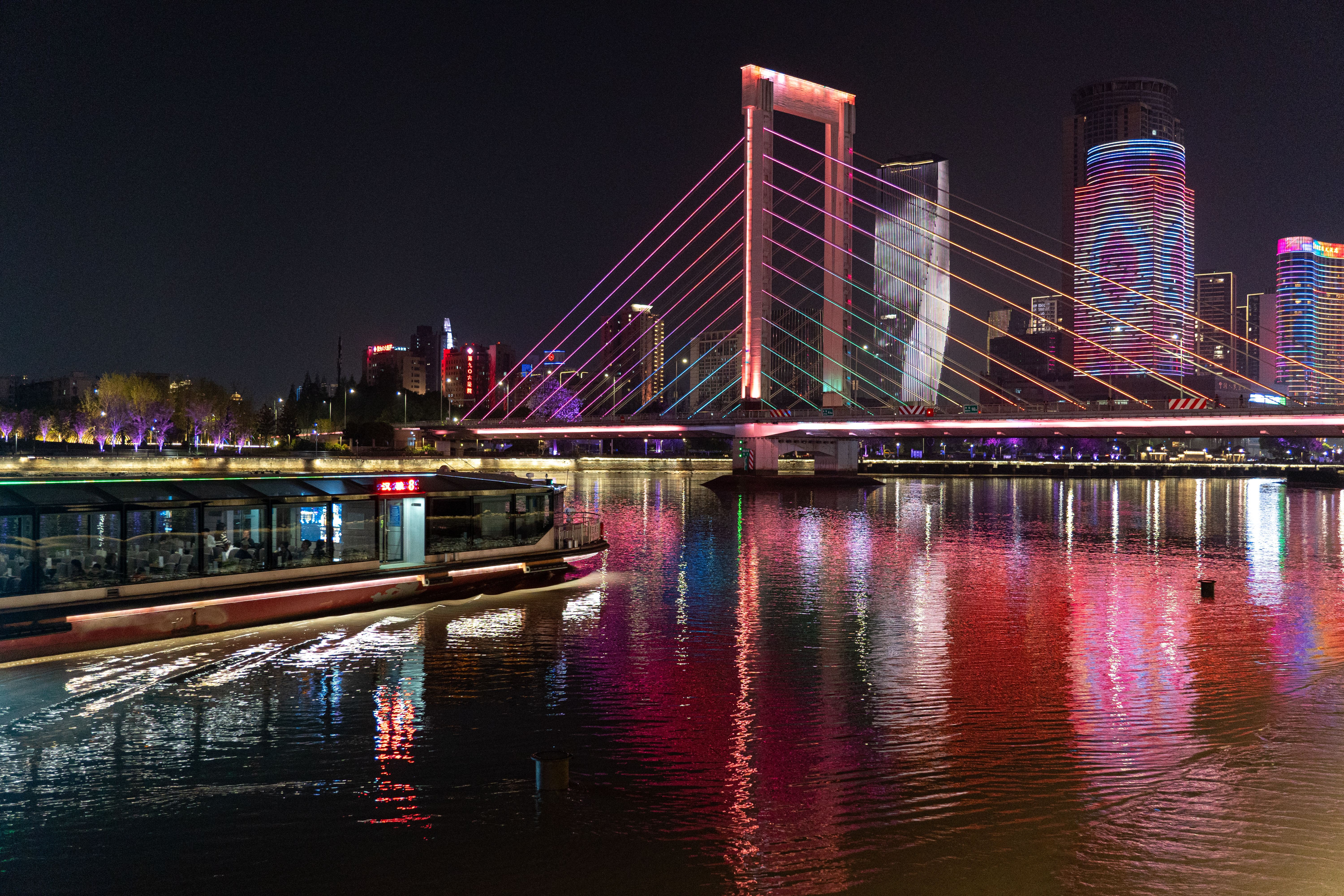 Vibrant Cityscape with Illuminated Bridge at Night · Free Stock Photo