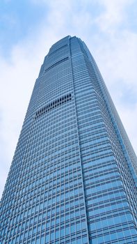 View of iconic International Finance Centre skyscraper in Hong Kong against a clear sky.