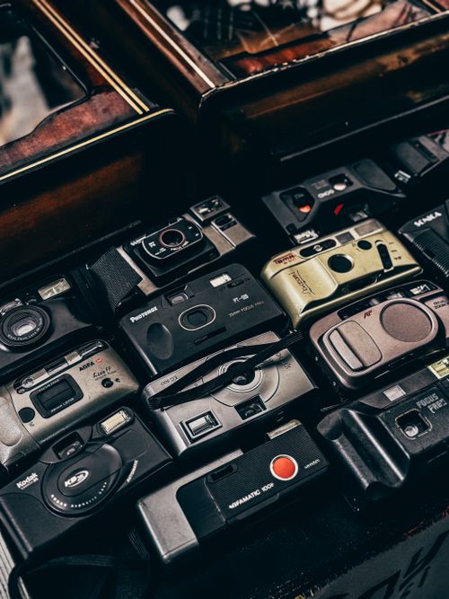 Free Assorted vintage film cameras arranged in a wooden display box. Stock Photo