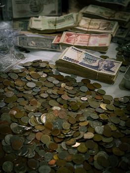 A collection of old coins and banknotes, highlighting vintage currency.