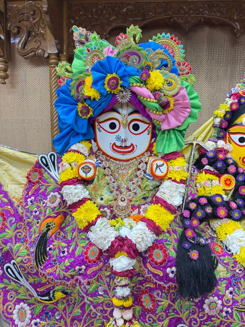 Free Colorful traditional Indian religious artwork with intricate details and vibrant florals. Stock Photo