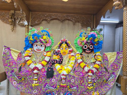 Free Vibrant Hindu deity statues adorned with flowers and intricate garments in a temple setting. Stock Photo
