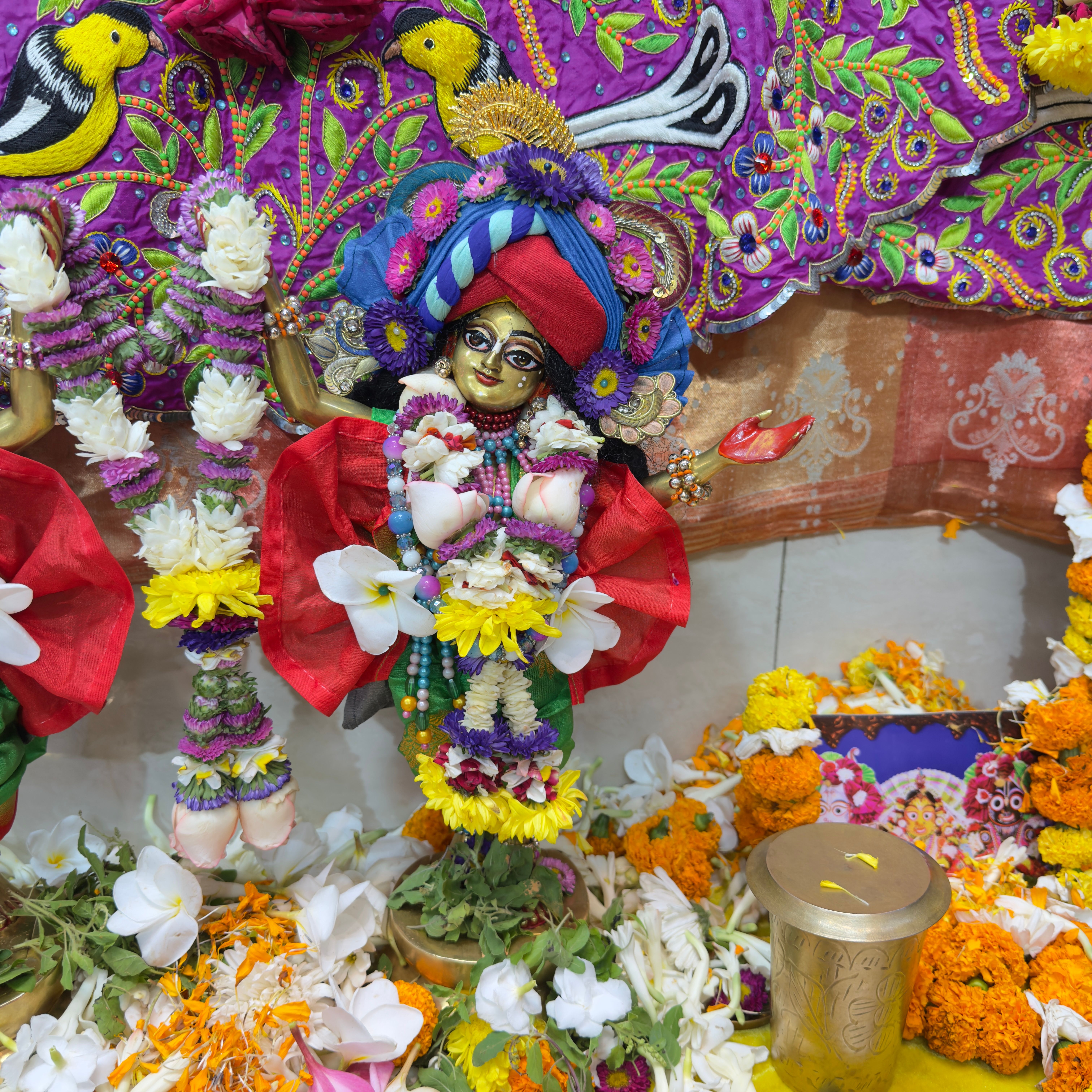 Close-up of temple bells, flowers, and incense