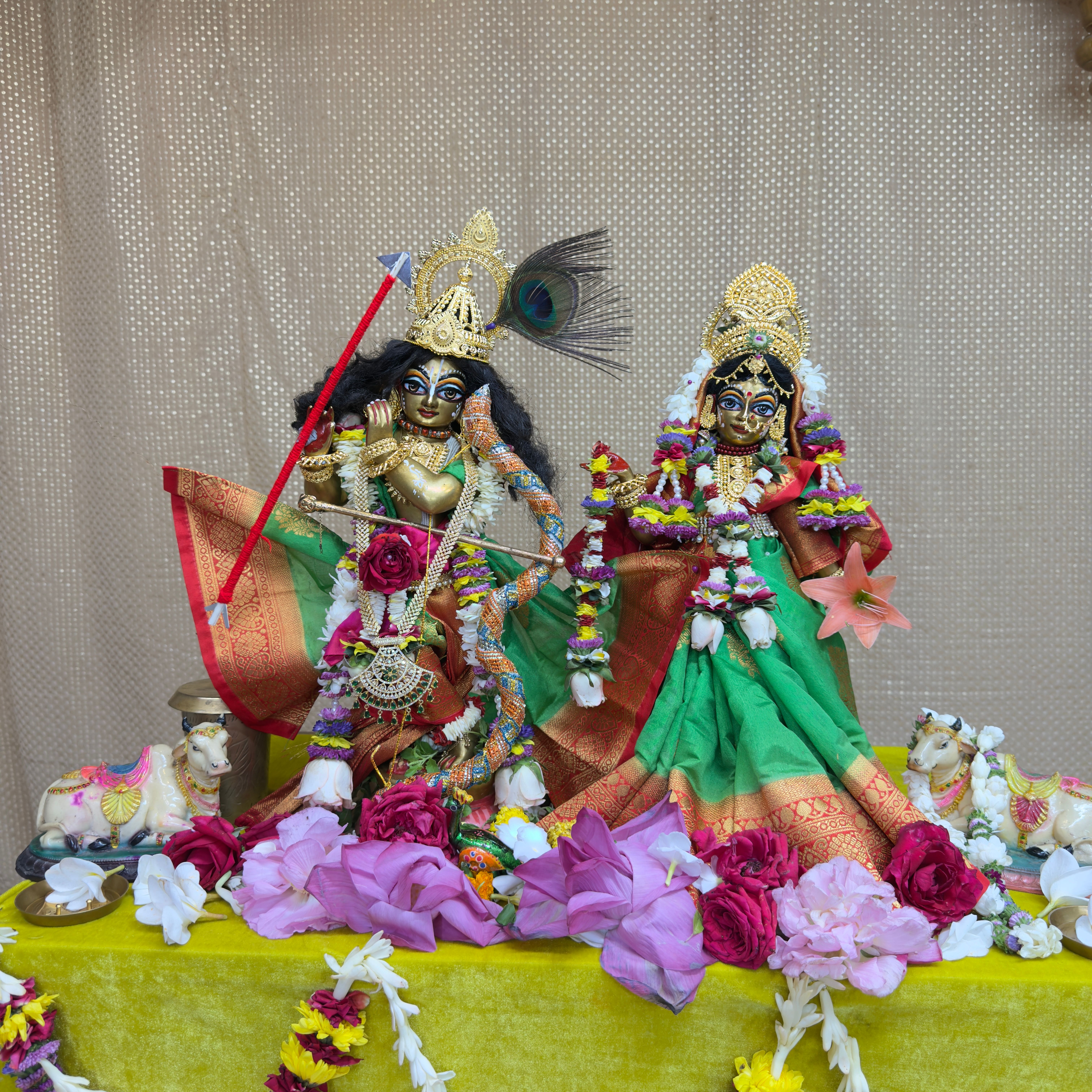 Devotees arranging flowers in a temple courtyard