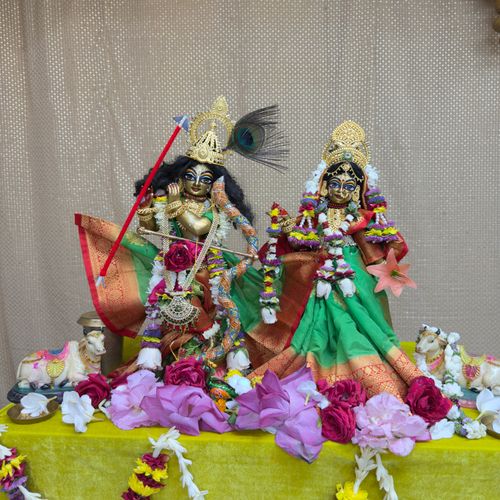 Free Vibrant depiction of Hindu deities adorned with flowers and traditional garments. Stock Photo