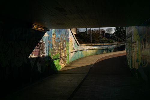 Free Colorful graffiti art under a tunnel in Kamen, Germany with striking light and shadow contrast. Stock Photo