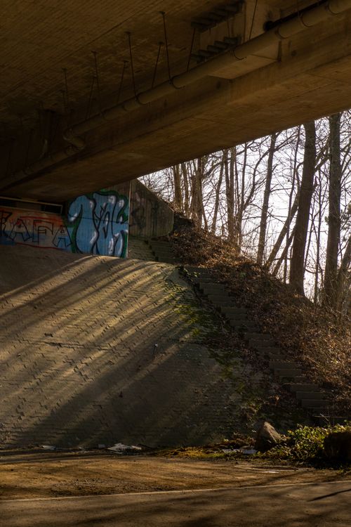 Free Graffiti art under a bridge in Kamen, Germany, showcasing urban culture and shadows. Stock Photo