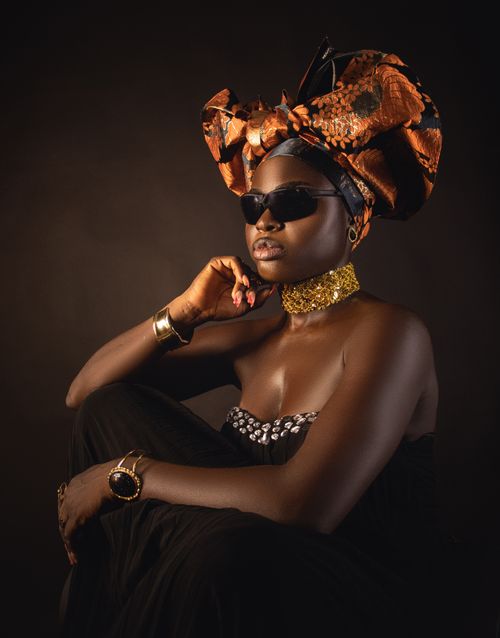 Free Stylish portrait of an African woman wearing a vibrant headwrap and elegant jewelry. Stock Photo