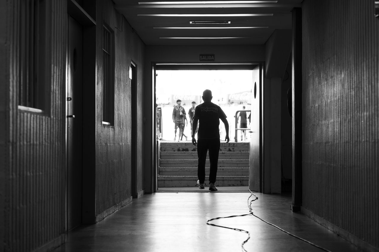 black and white photo capturing a dramatic silhouette of a man in a c