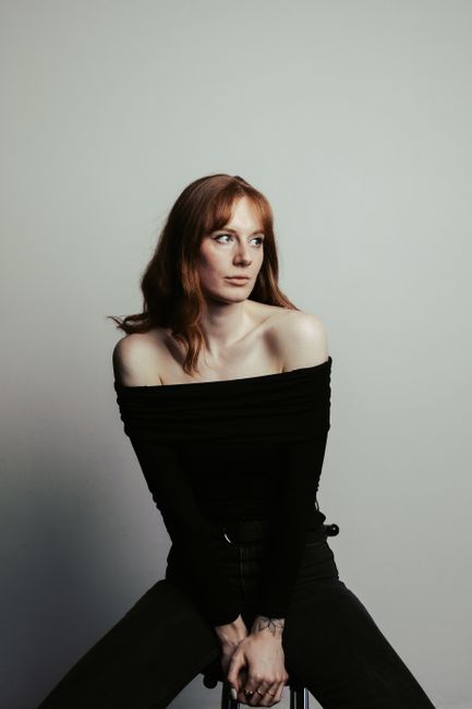 Elegant studio portrait of a woman in Berlin with classic style and soft lighting.