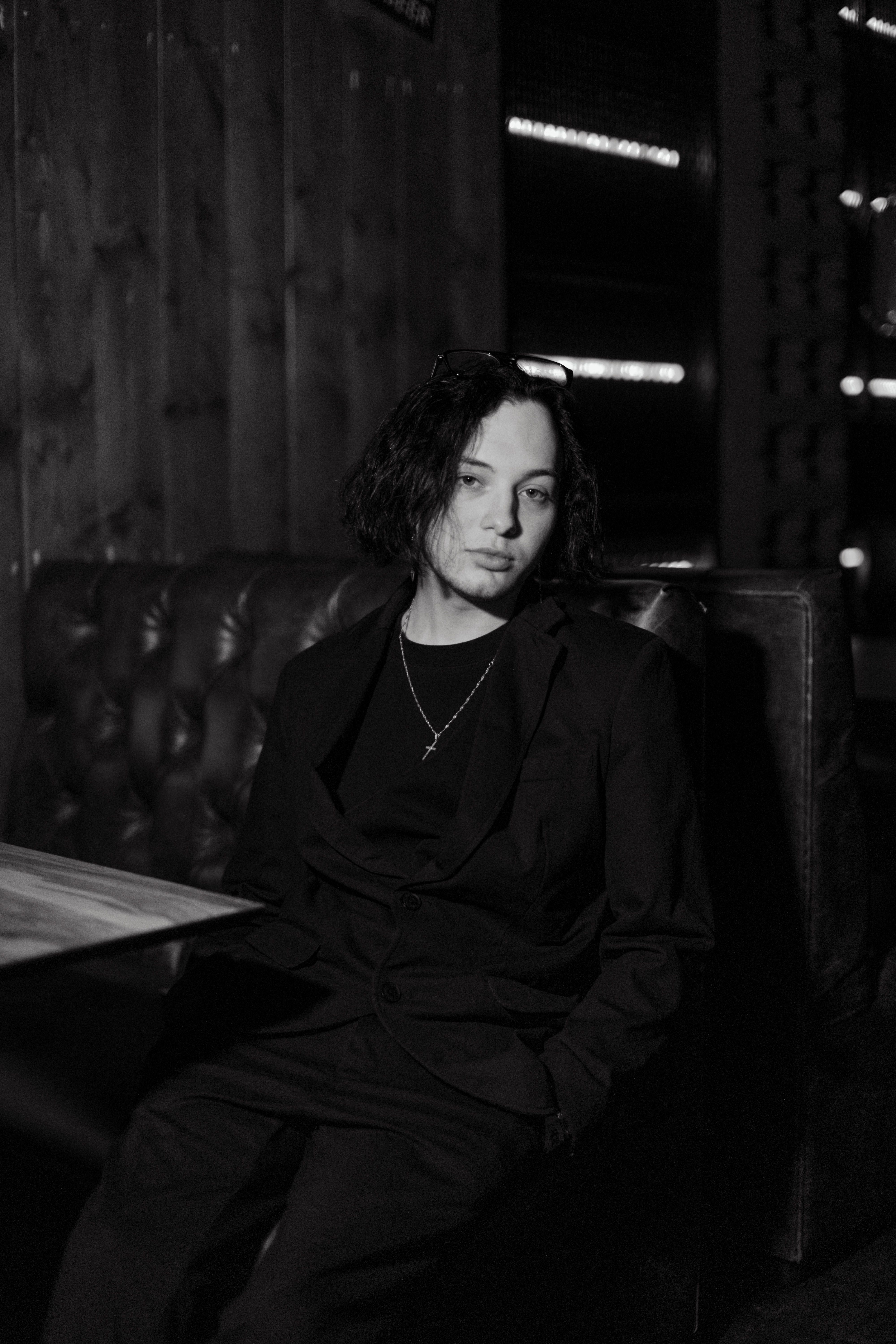 Elegant black and white portrait of a person in a stylish cafe setting