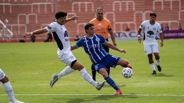 Soccer players in action during an outdoor match with a referee.