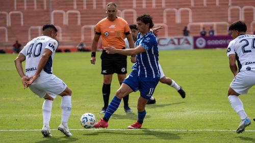 Free Action-packed soccer match with players in motion on the field during a competitive game. Stock Photo