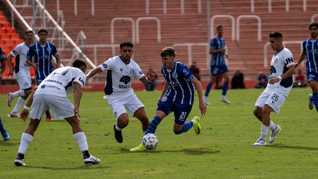 Dramatic moment in a soccer match with players vying for the ball on a sunny day. Perfect for sports content.