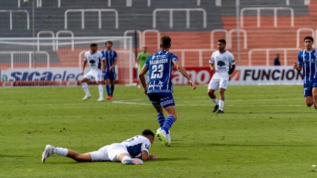 Intense soccer match with players in action on the field.
