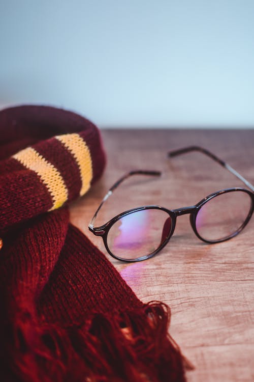 Free Scarf and Eyeglasses on the Table Stock Photo
