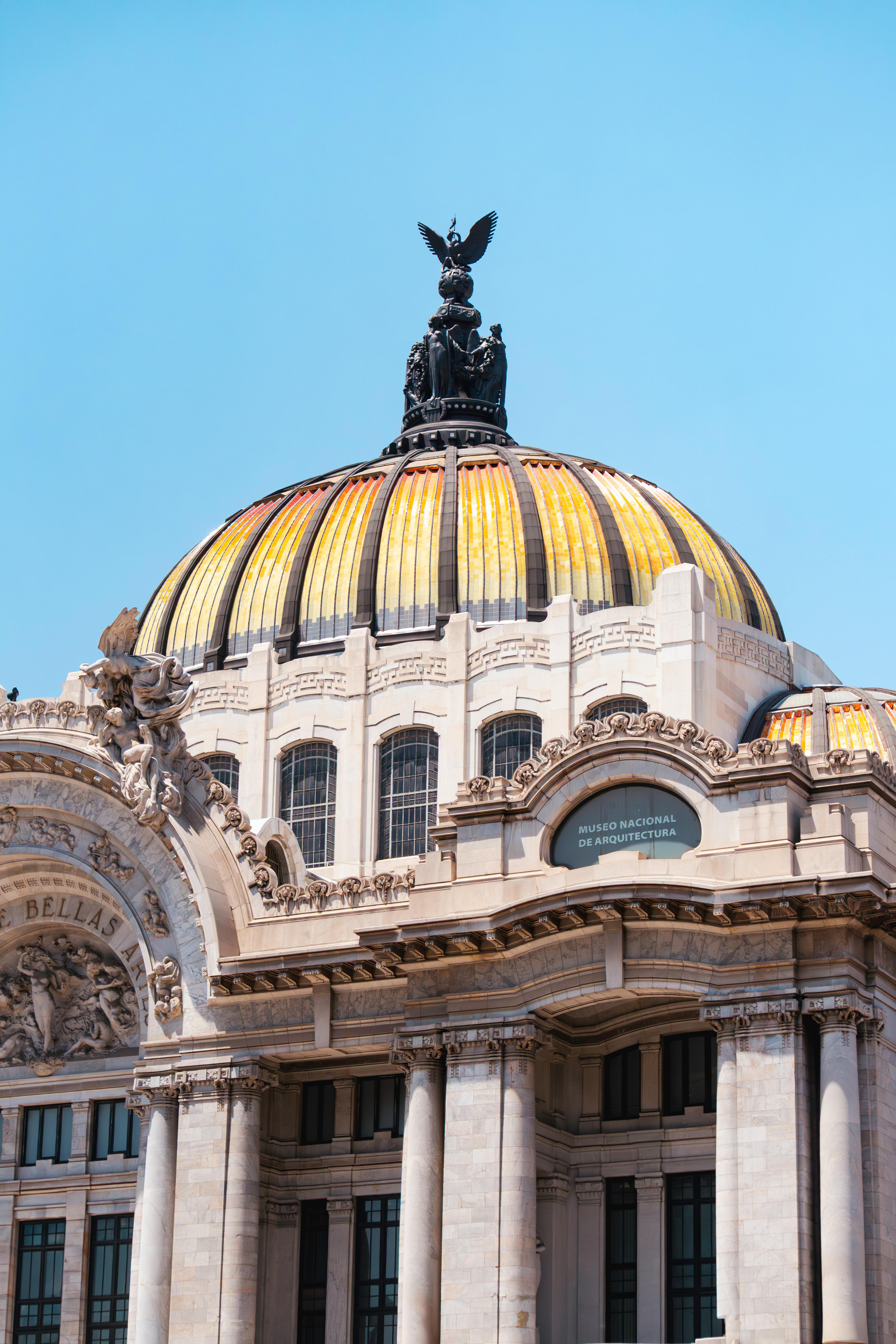 Stunning view of the Palacio de Bellas Artes dome under a clear blue sky in Mexico City.
