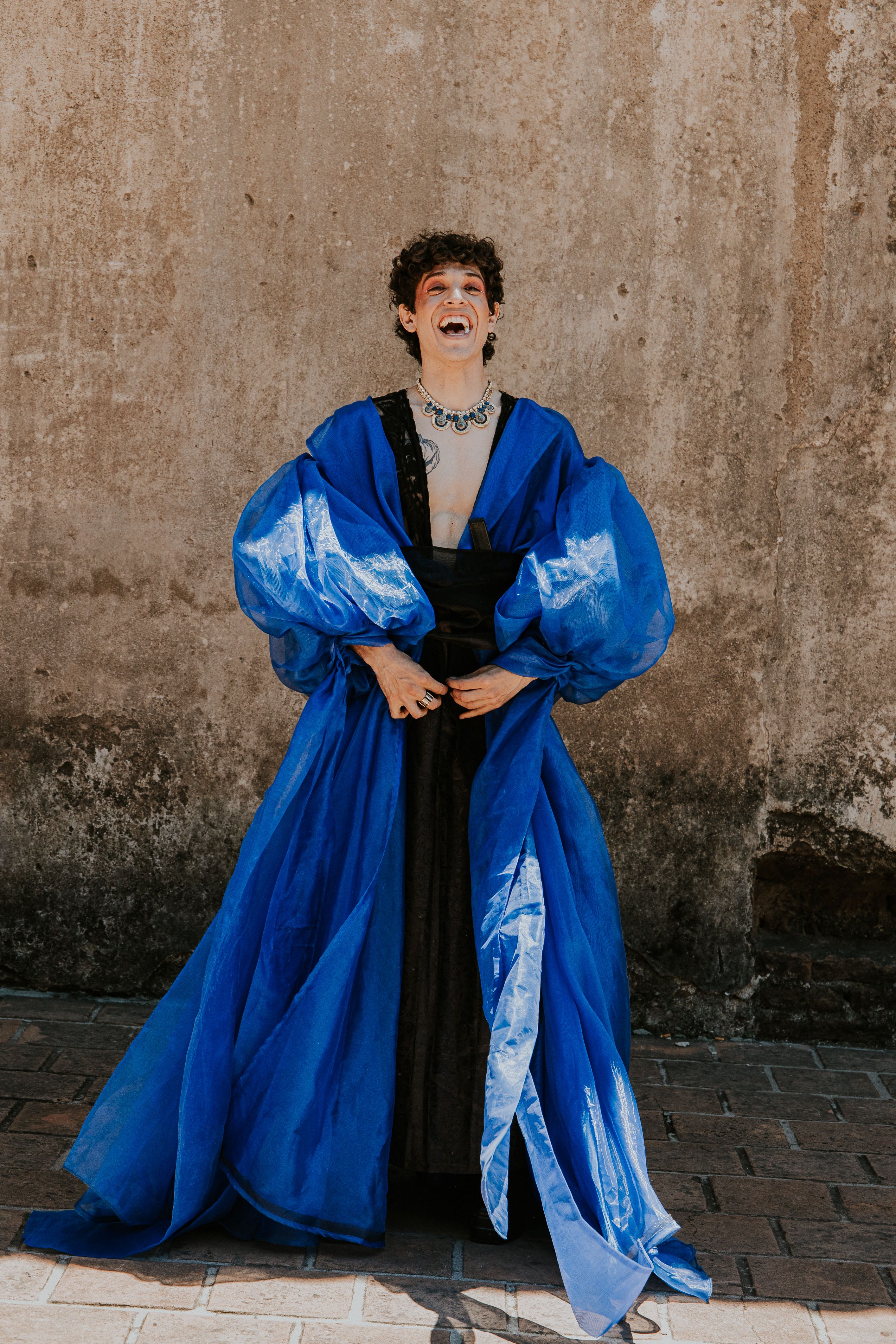 Stylish Individual in Vibrant Blue Robe Outdoors · Free Stock Photo