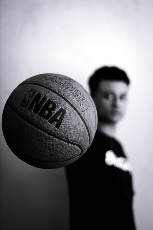Free Grayscale Photo of Man Holding Nba Basketball Stock Photo