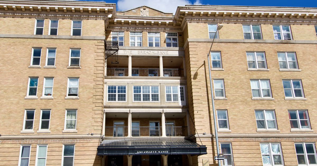 Facade of a historic apartment building in Winnipeg, Manitoba, captured on a sunny day.