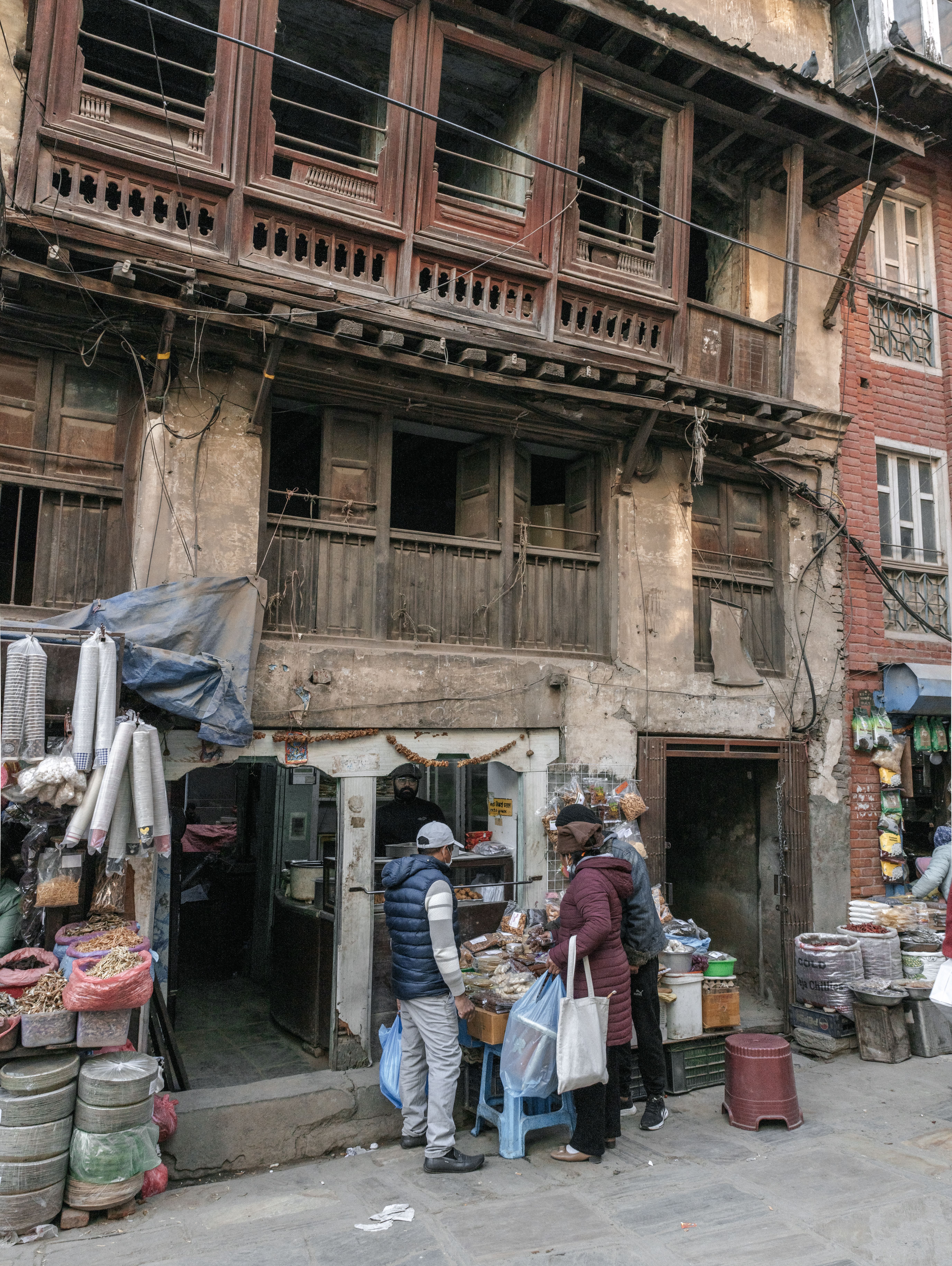 A traditional Newari shopfront and market stalls in Kathmandu's old town